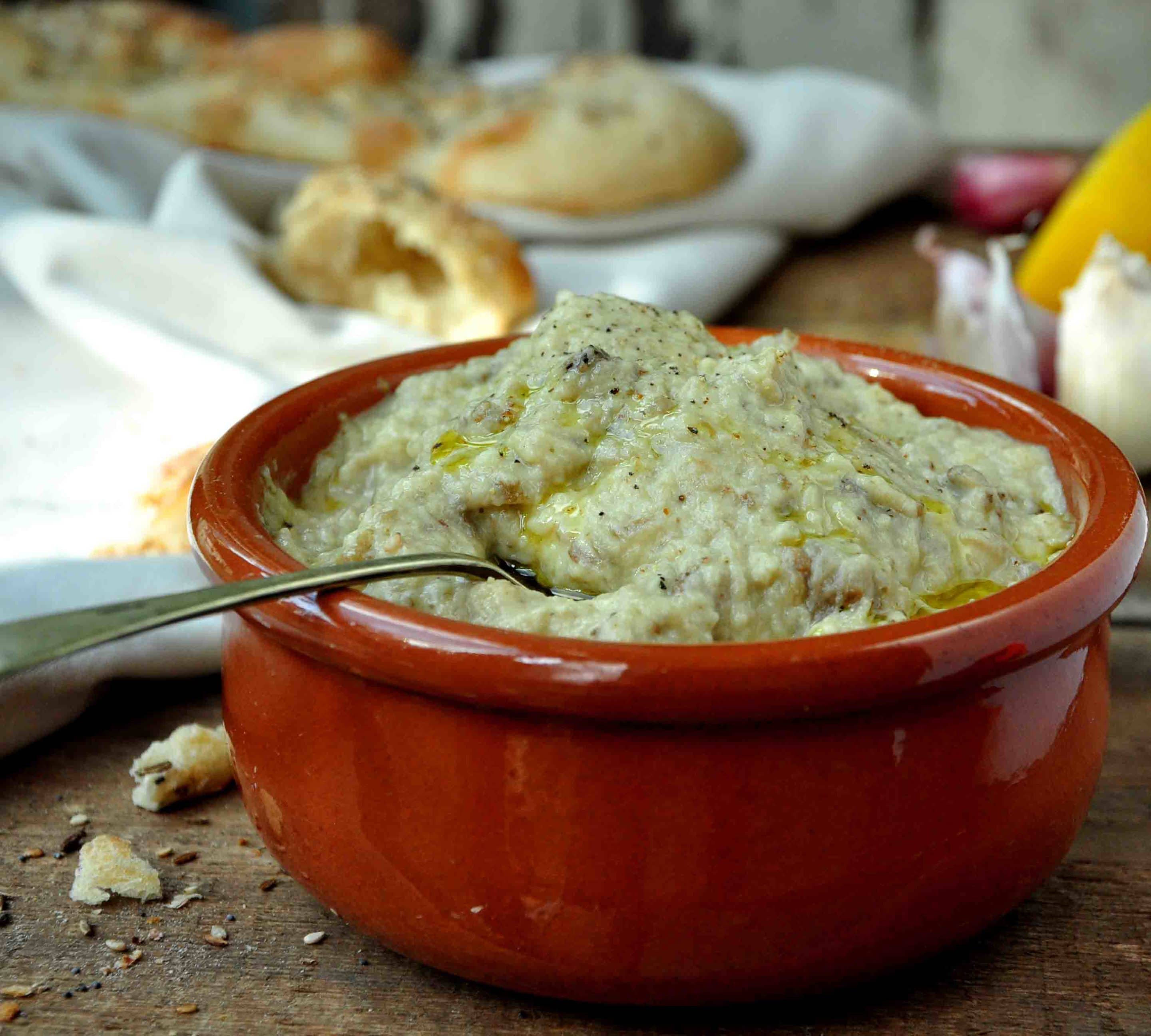 a terracotta dish with an aubergine dip for serving with flat breads as part of a mezze
