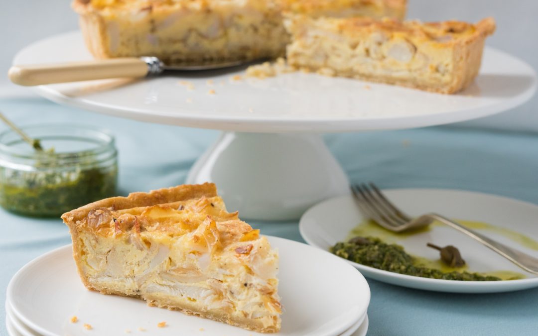 A slice of deep filled smoked haddock tart made with Parmesan pastry