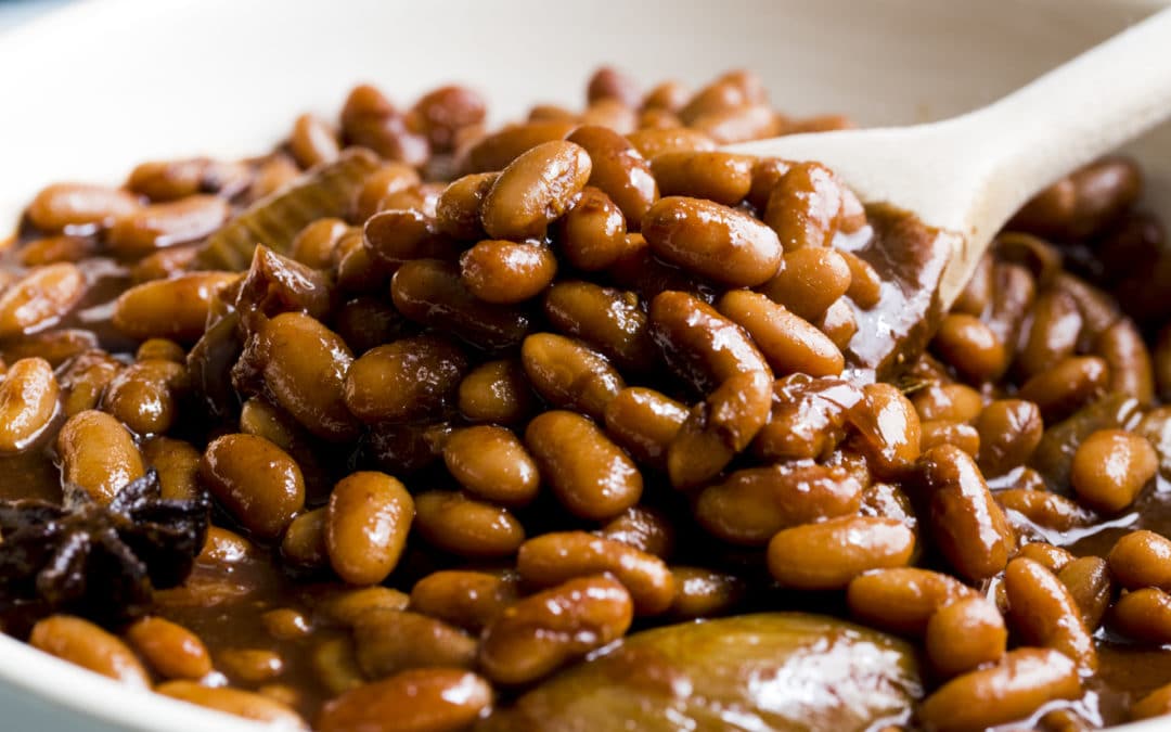 cennellini beans in a dark sticky sauce made with beer and molasses