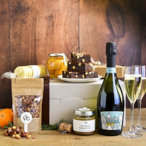 A celebration gift hamper with chocolate brownies and prosecco
